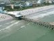 drone-video:-surfers,-beachgoers-at-cocoa-beach-pier,-great-place-to-watch-rocket-launch